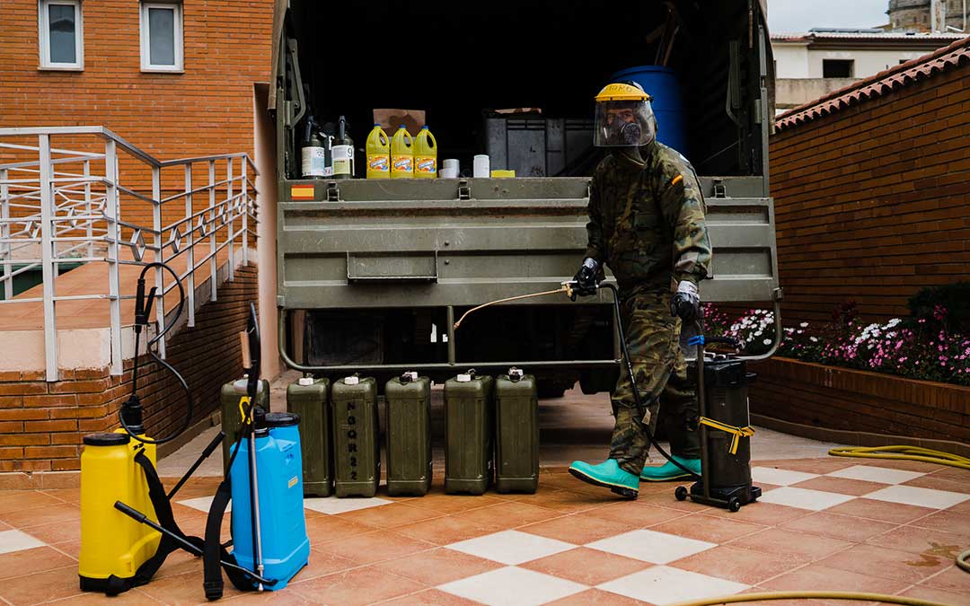 Un miembro del Ejército de Tierra cogiendo los utensilios de desinfección. Imagen: Césareo Larrosa.