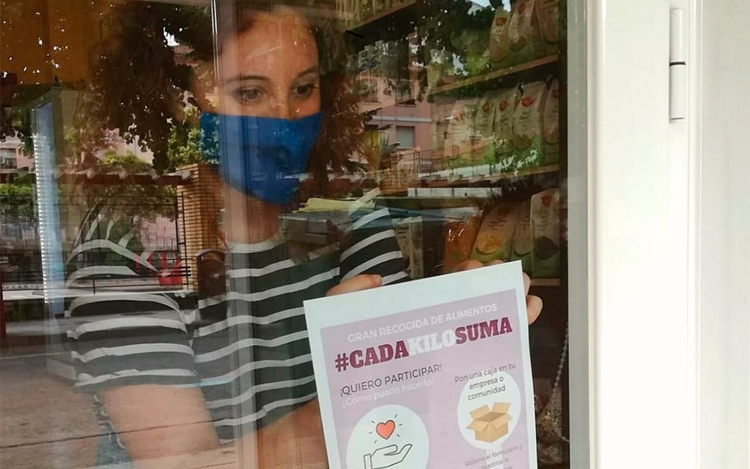 Scouts de Alcañiz reparte carteles de la recogida de alimentos en los comercios./ Alba Biel