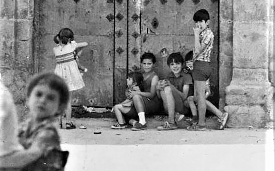 Unos niños juegan en la puerta de la iglesia, en una images de los años 70. /Foto cedida del Archivo familiar familia Oliveros