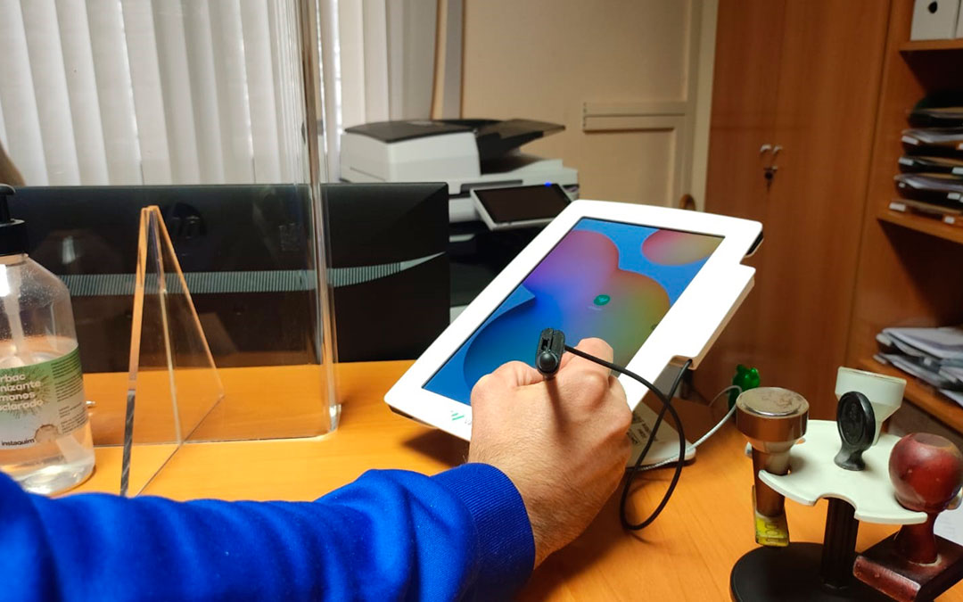 Un ciudadano haciendo uso de la tablet que permite la firma biométrica en el Registro Municipal./ Ayto. de Andorra