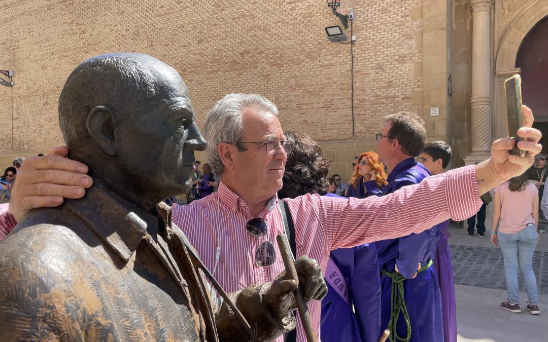 Un turista se hace un selfie con la estatua de Buñuel./ M. Celiméndiz