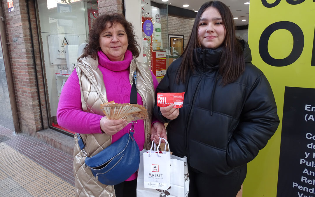 Belén Alcón y Beatriz Lizana, madre e hija junto a los 3.000 euros en efectivo y el boleto ganador del sorteo de ACSA. / A.Z