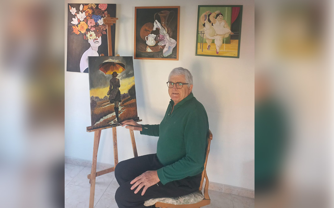 José Miguel Pradilla, en su estudio rodeado de cuadros que expuso en la muestra colectiva en Maella. / Archivo personal