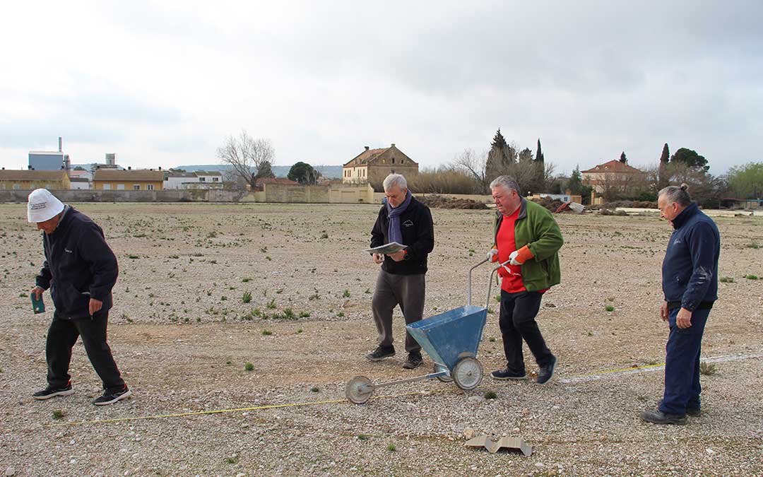Voluntarios marcando las plazas de aparcamiento en la Azucarera a golpe de carretilla para la Tamborada Nacional. / B. Severino